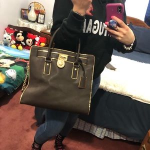 Michael Kors tote in dark brown and gold .